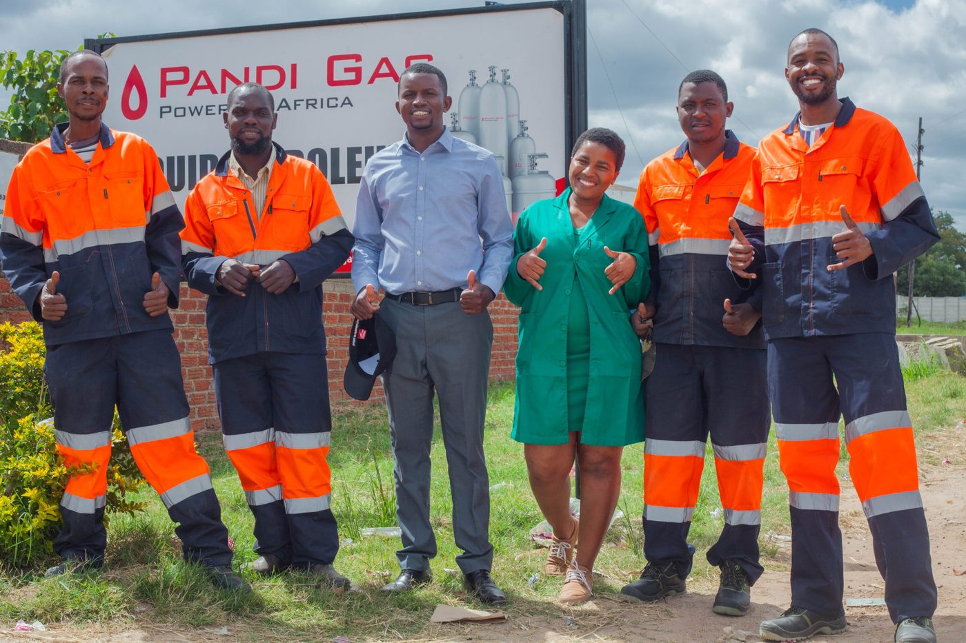 Pandi Energy operations staff giving thumbs up at a branch
